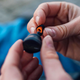 Hands holding a Free Byrd earbud and a silicone tip